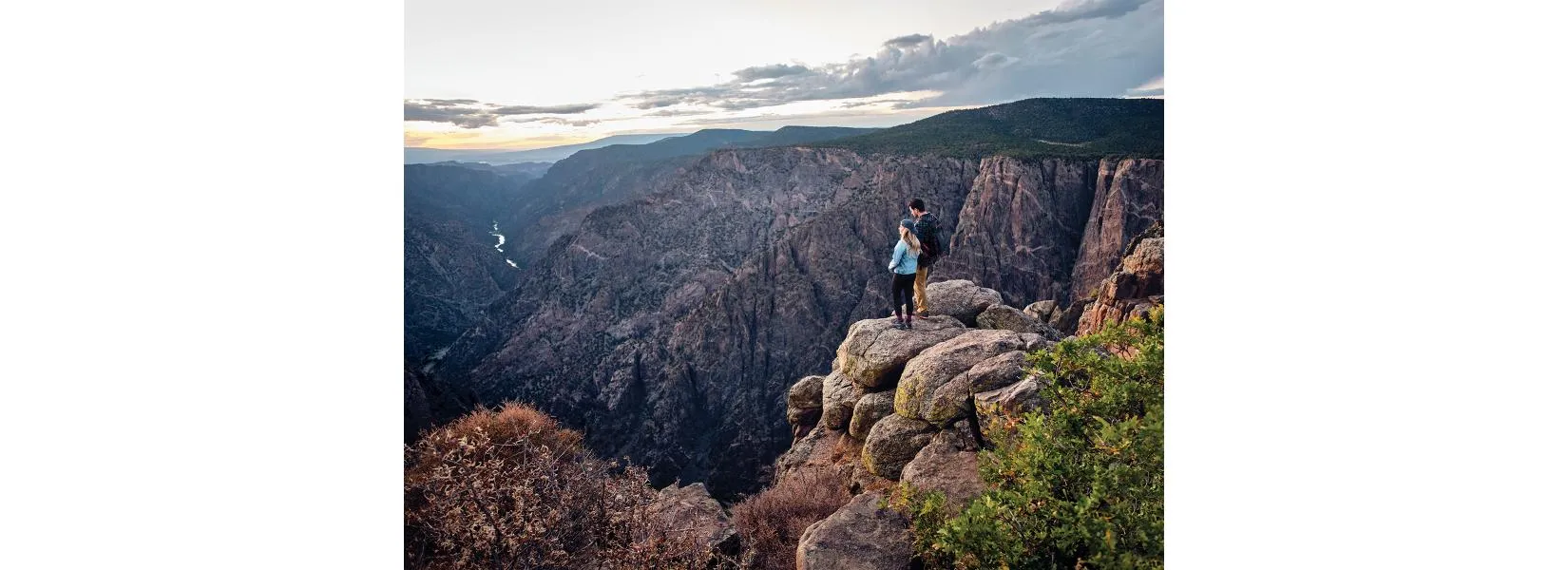 Sunset view from Black Canyon of the Gunnison South Rim showing golden light on canyon walls